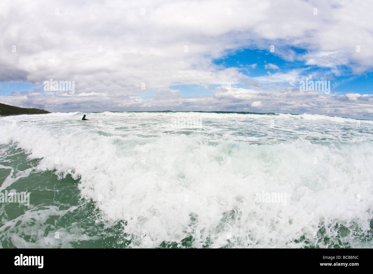 Surfing waves off Porthmeor beach summer sun St Ives Cornwall England