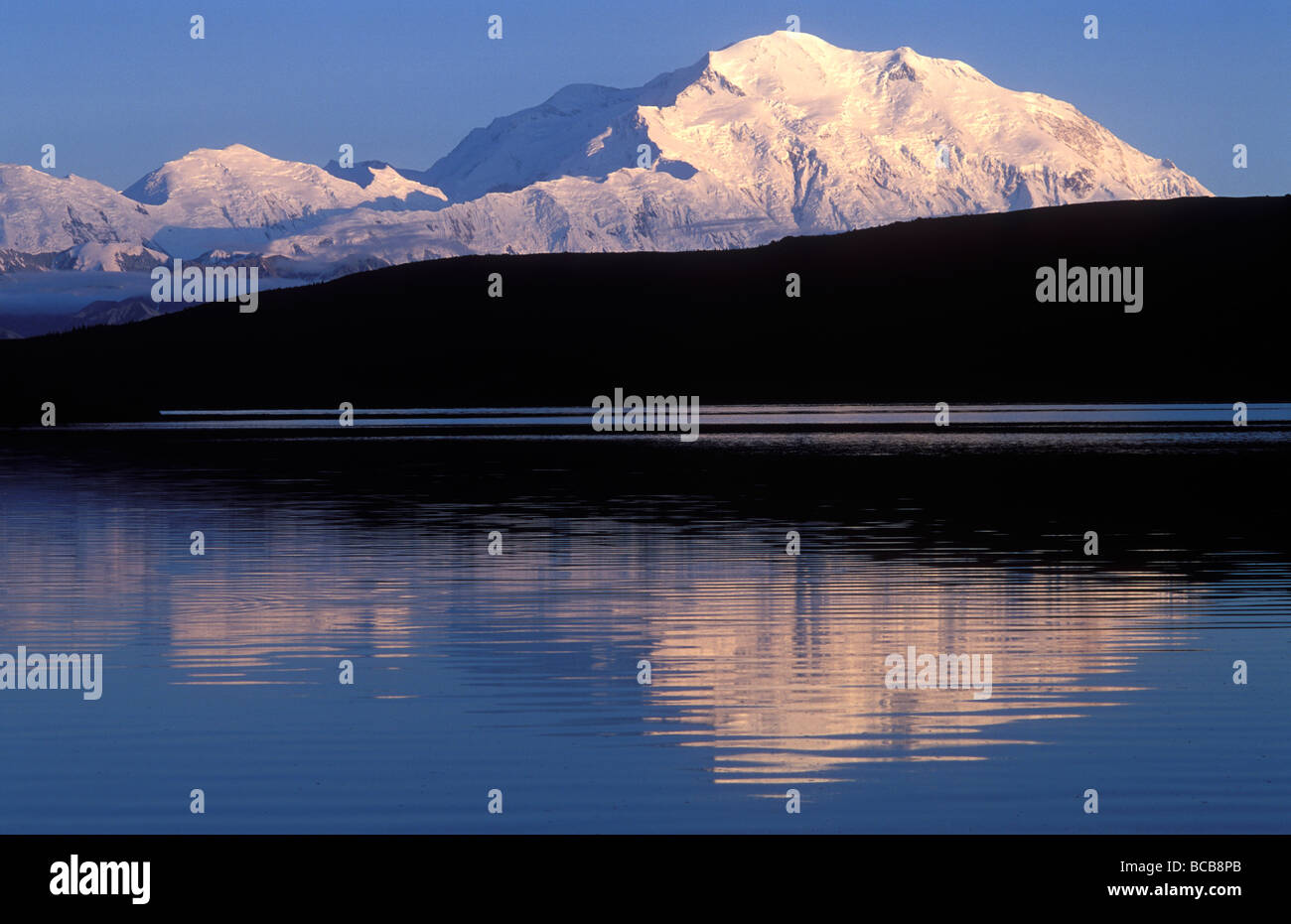 Midnight alpenglow on Mount McKinley reflecting in Wonder Lake. Stock Photo