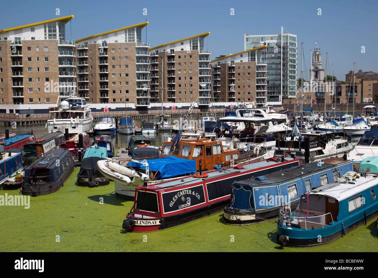 Limehouse Basin / Marina with narrow boats and duckweed Stock Photo