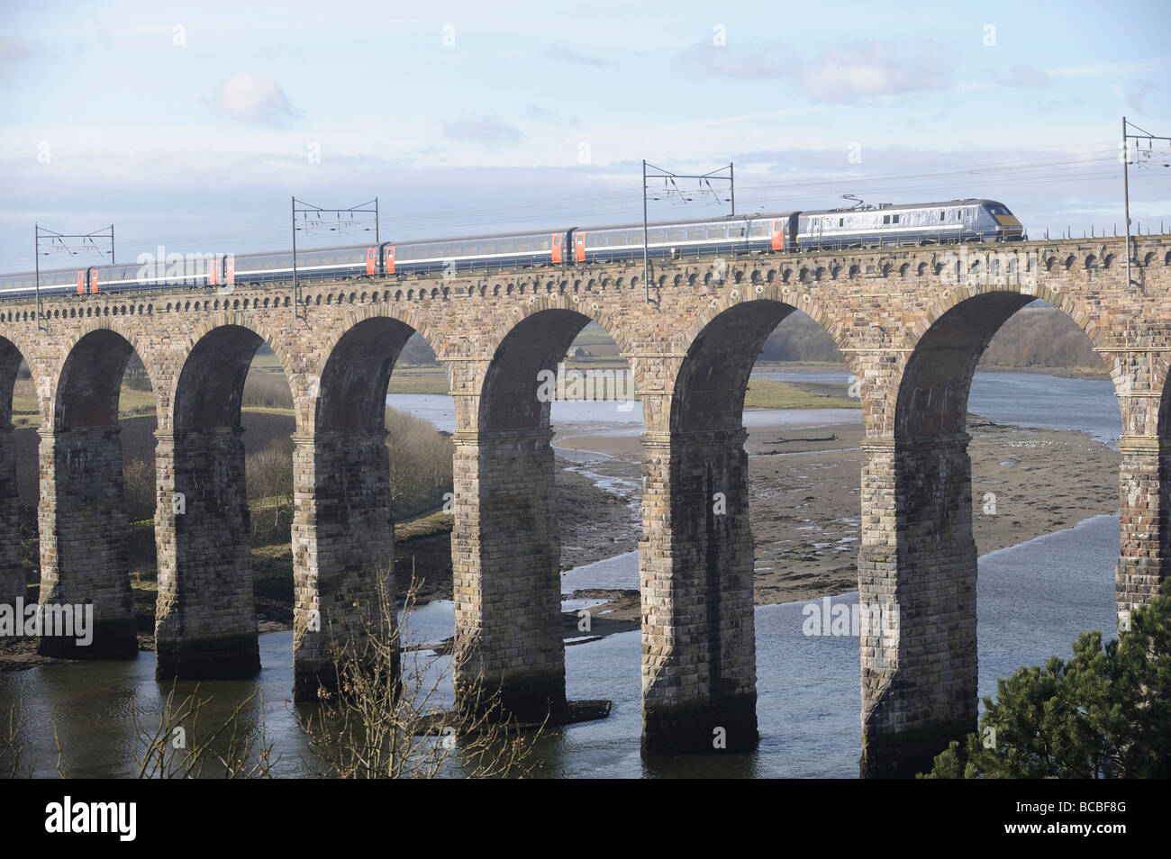 A National Express train travelling over the Royal Border Bridge on the East Coast Main Line between London and Scotland Stock Photo