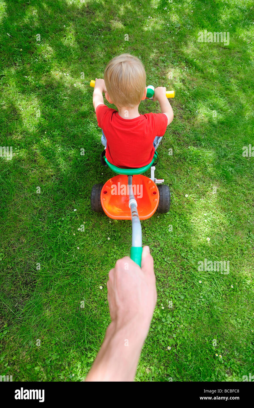 Three year old boy riding tricycle Stock Photo Alamy