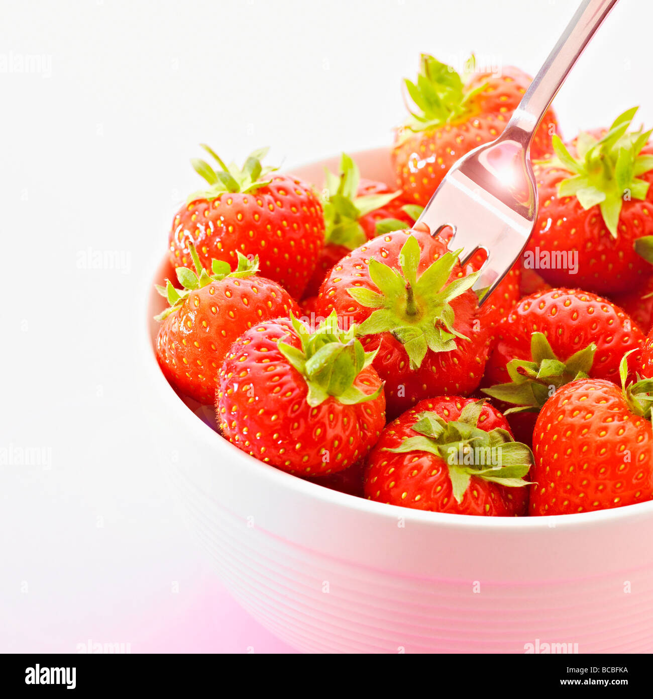 Bowl of fresh summer strawberries with silver fork Stock Photo - Alamy