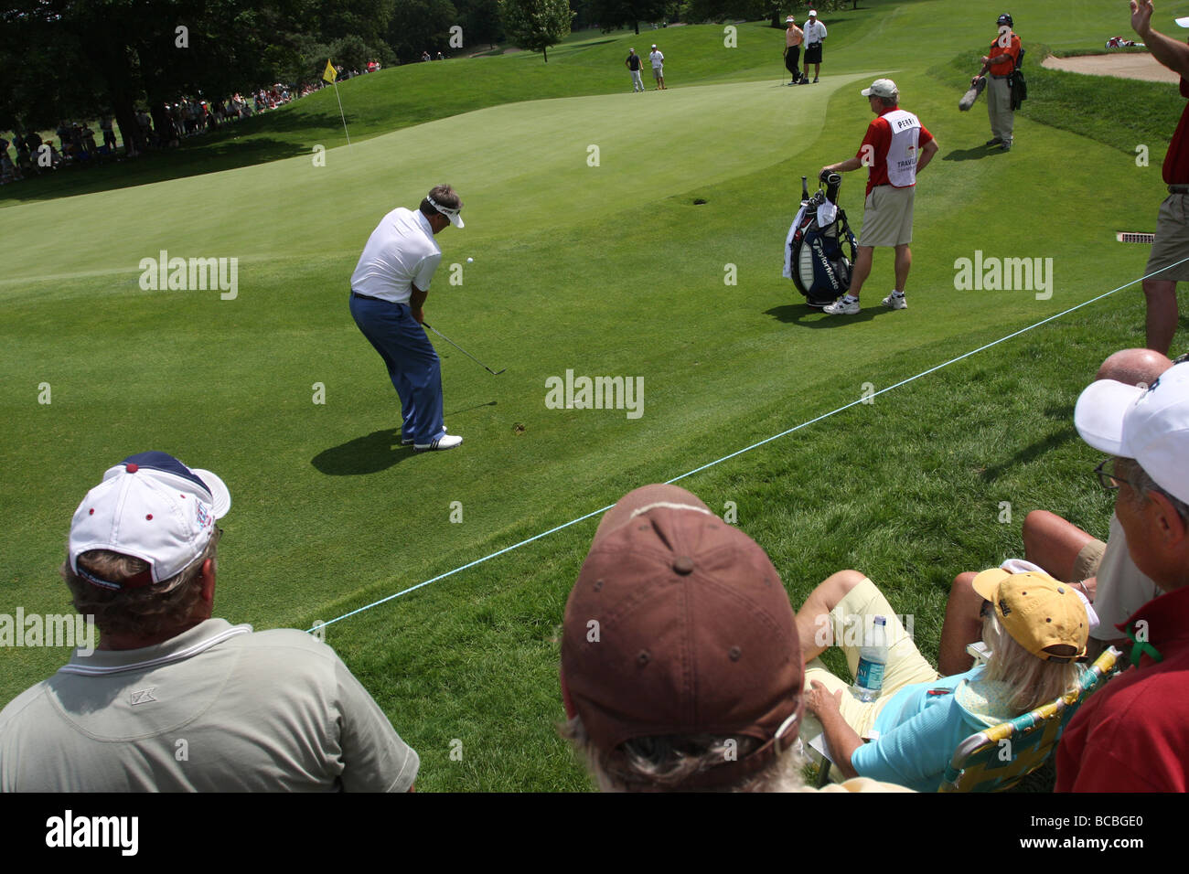 Fans watch a pro golfer during the Travelers Championship golf