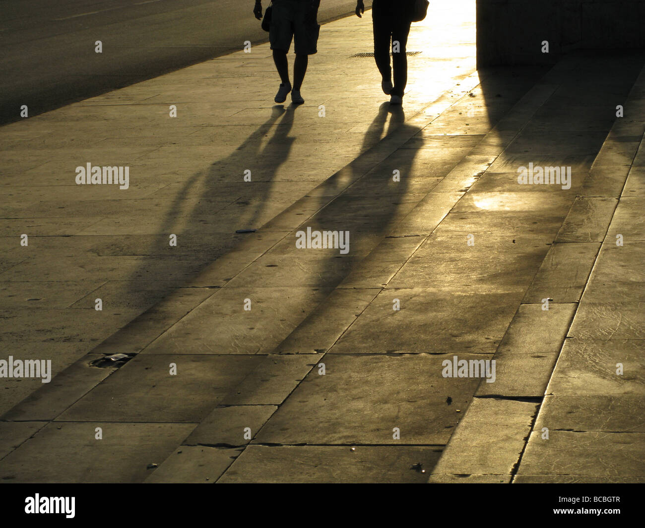 two people walking in street road in city town Stock Photo