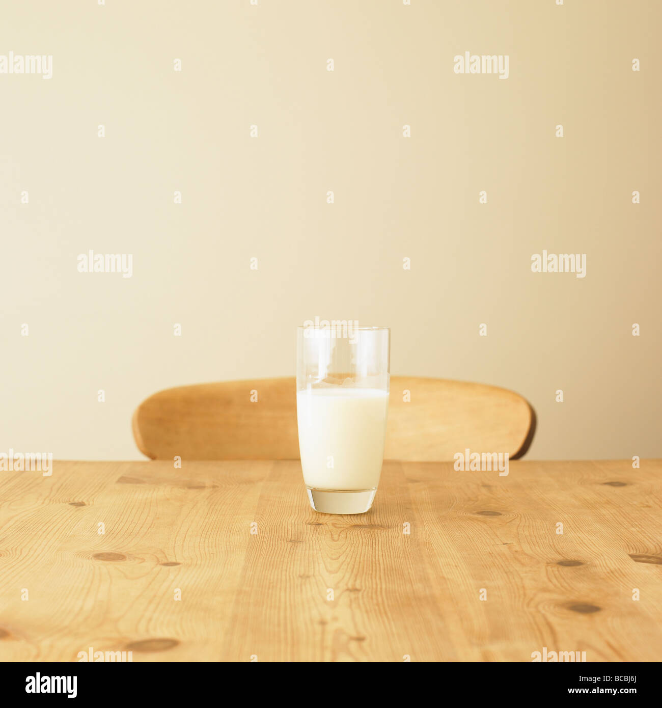 Glass of milk on rustic kitchen table. Stock Photo