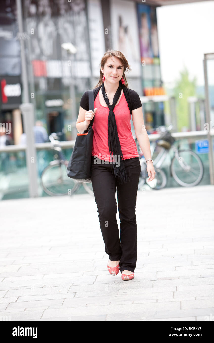 Beautiful young woman walking in shopping center Stock Photo - Alamy