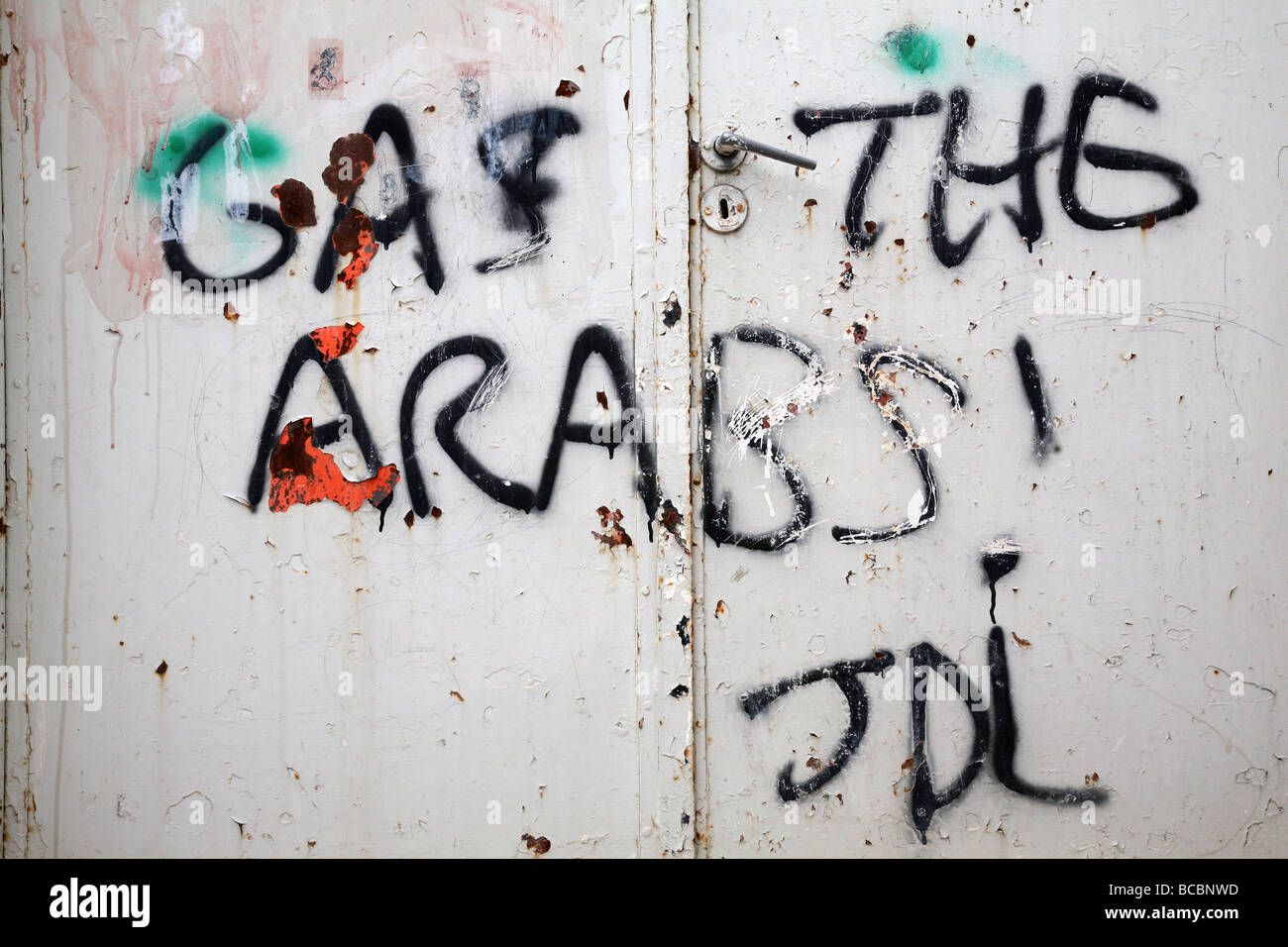 Jewish settler graffiti on the gate of a Palestinian house in the Israeli controlled old city area of Hebron in the West Bank. Stock Photo