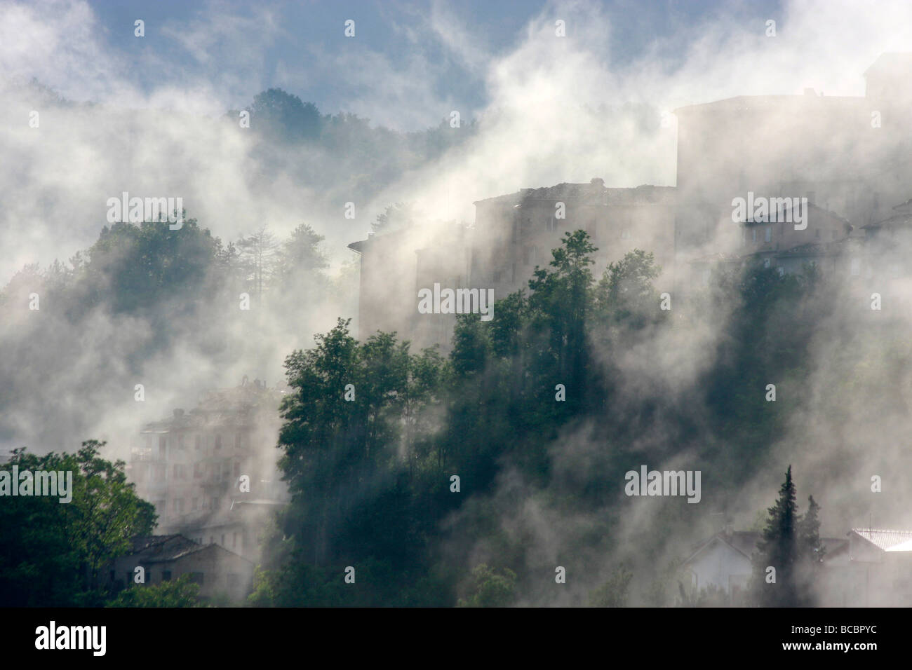 Atmospheric Clouds envelope the historic hilltown of Amandola in the Marche,Marches,in Italy Stock Photo