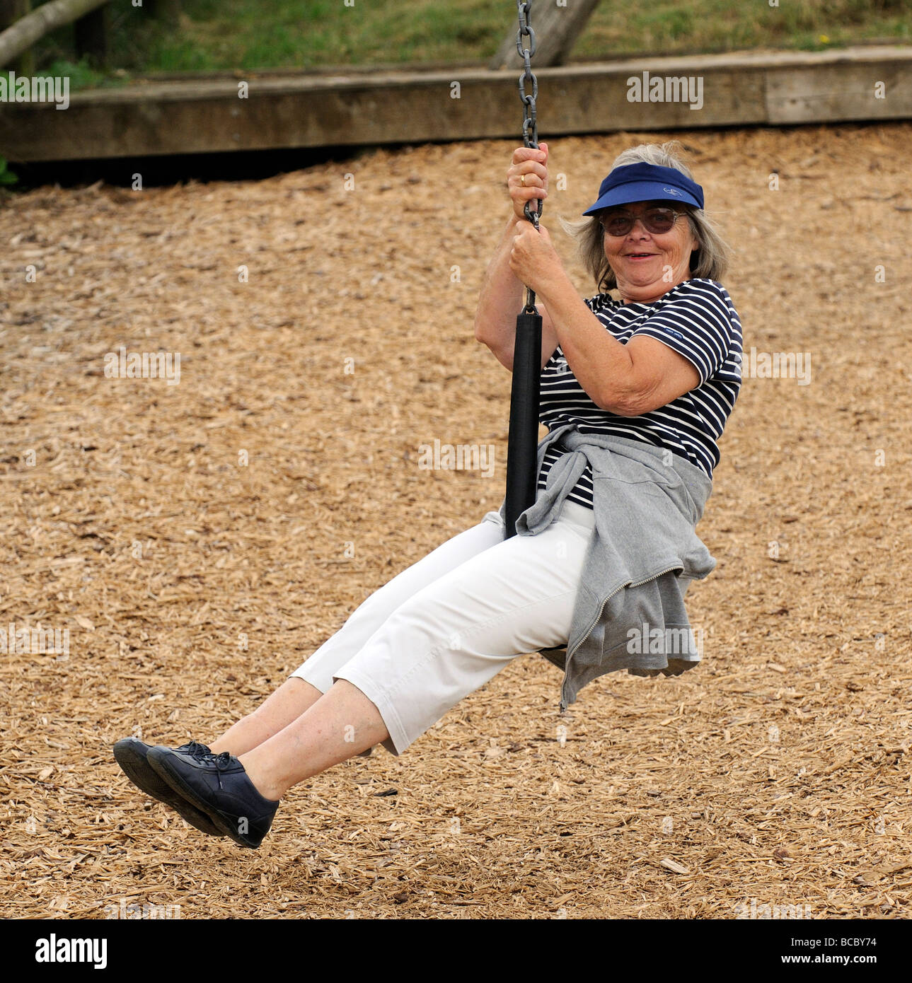 Elderly woman taking a zipline ride and enjoying her retirement years Stock Photo Alamy