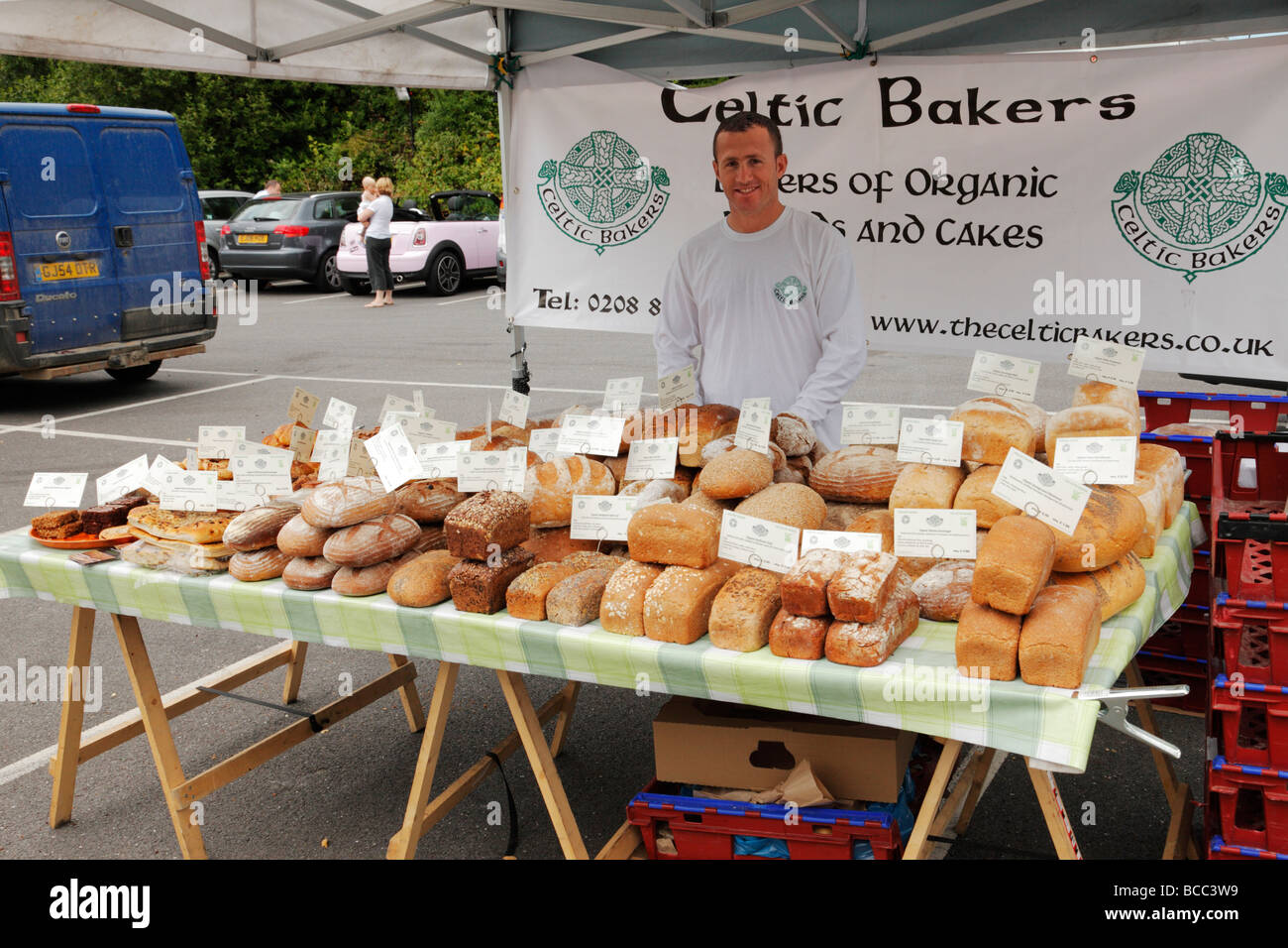 Man selling bread for sale at local farmers market. Westerham, Kent, England, UK. Stock Photo