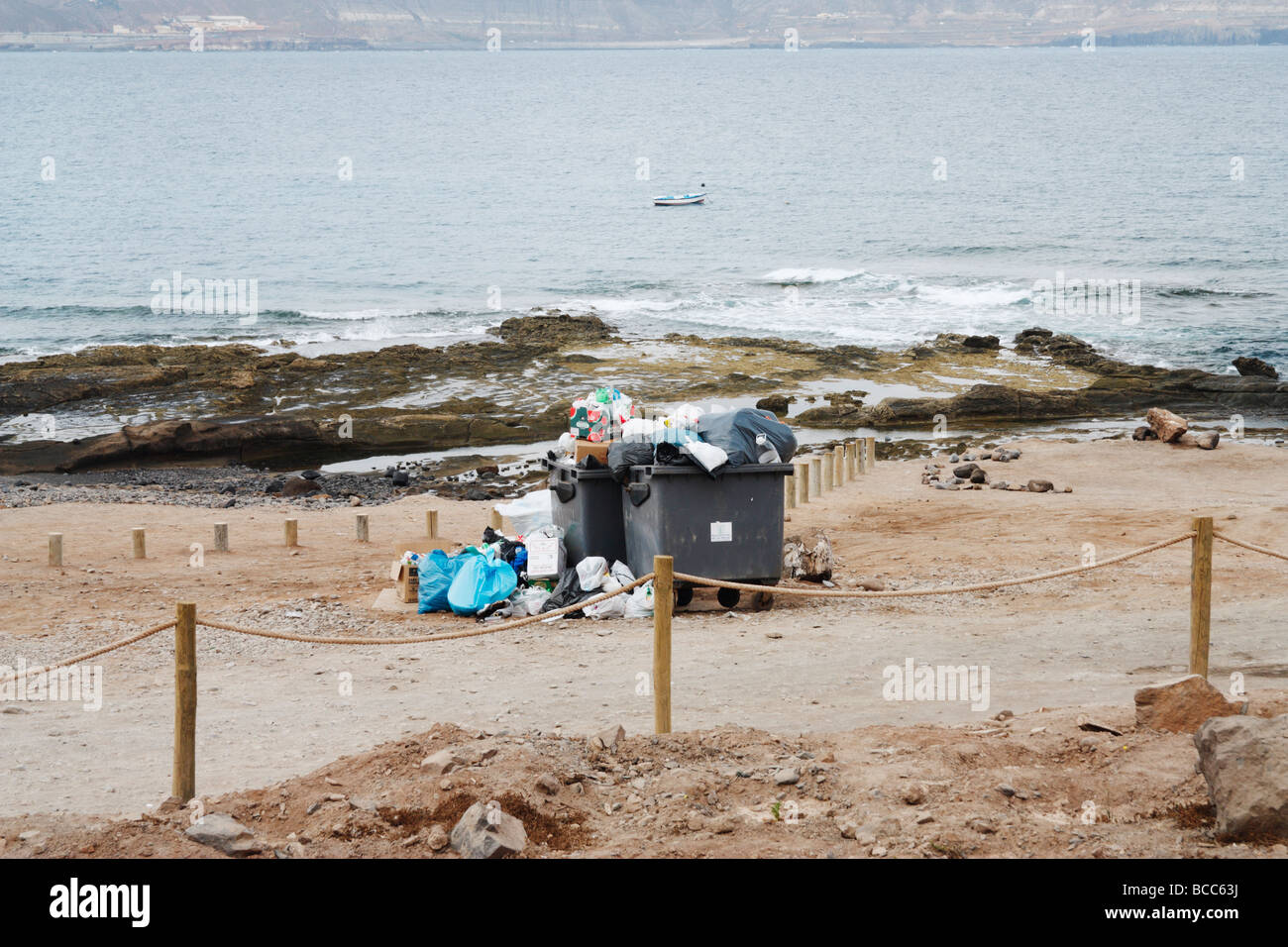 Piles of rubbish around rubbish containers after weekend crownd near beach in Spain Stock Photo