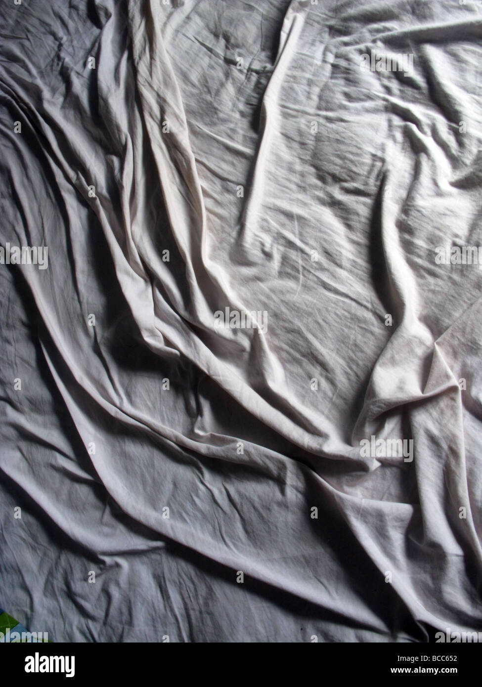 creases on bed sheet in dark room Stock Photo Alamy