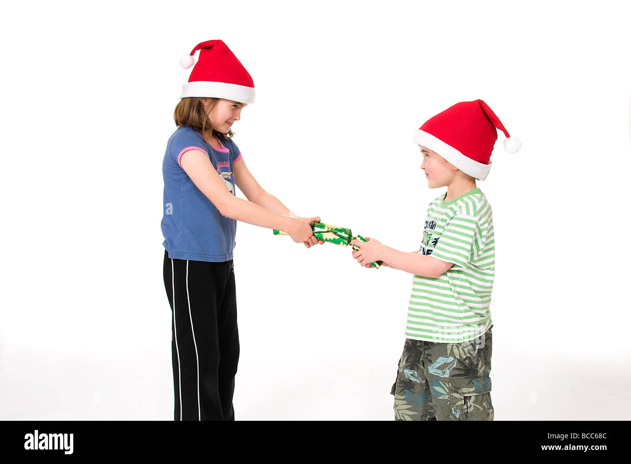 Young Children Pulling a Christmas Cracker Stock Photo