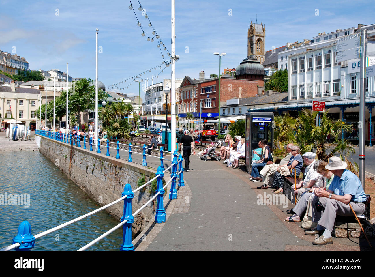 tourists relaxing at the harbour in torquay, devon, uk Stock Photo