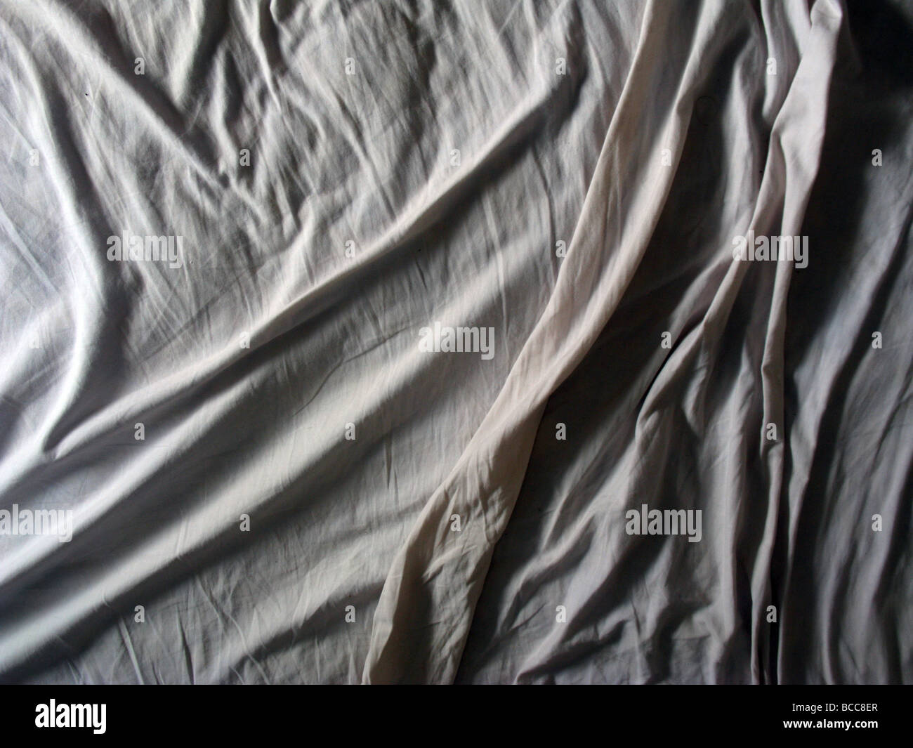 creases on bed sheet in dark room Stock Photo Alamy