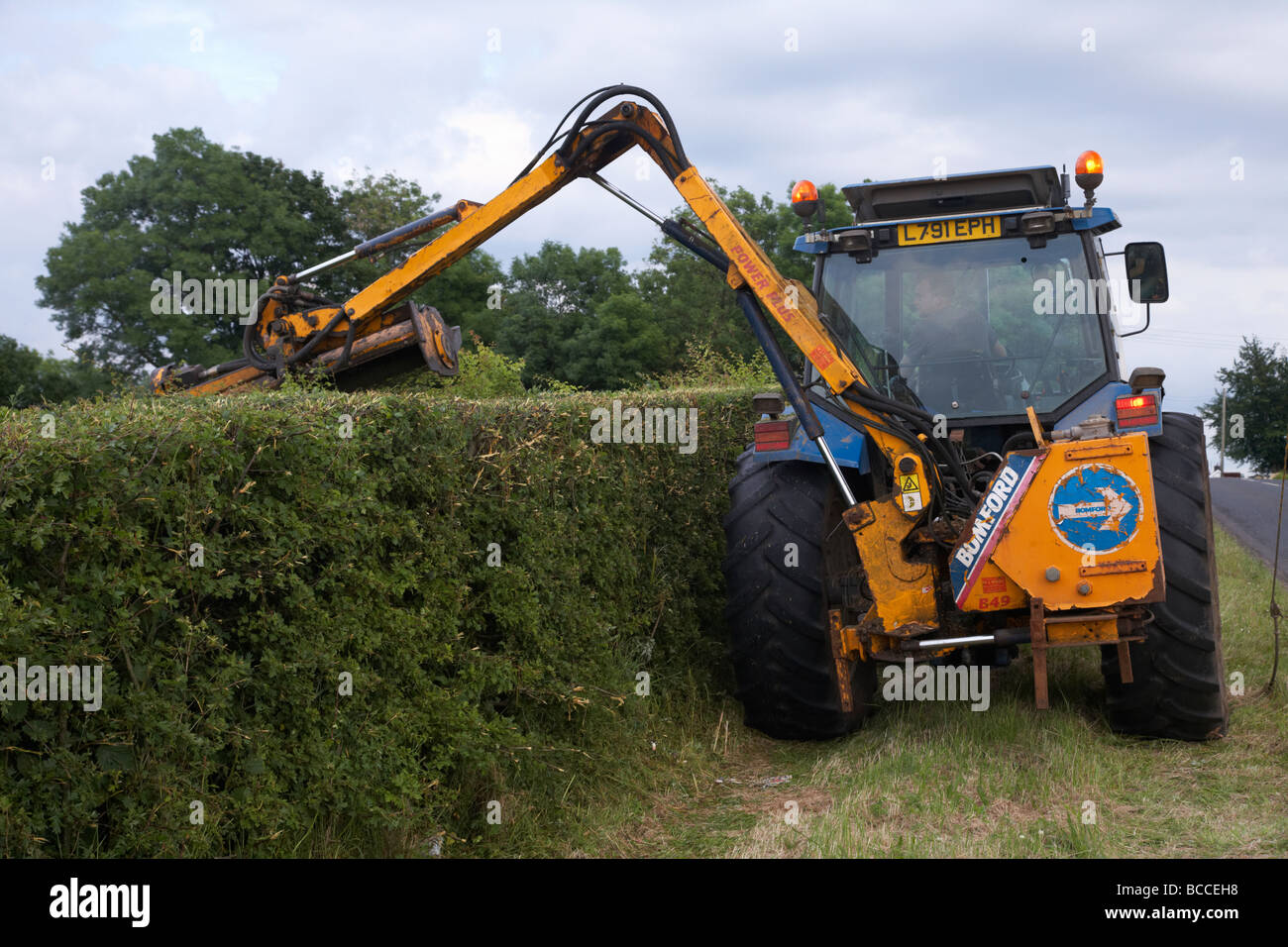 tractor trimming pruning and cutting roadside hedges county antrim