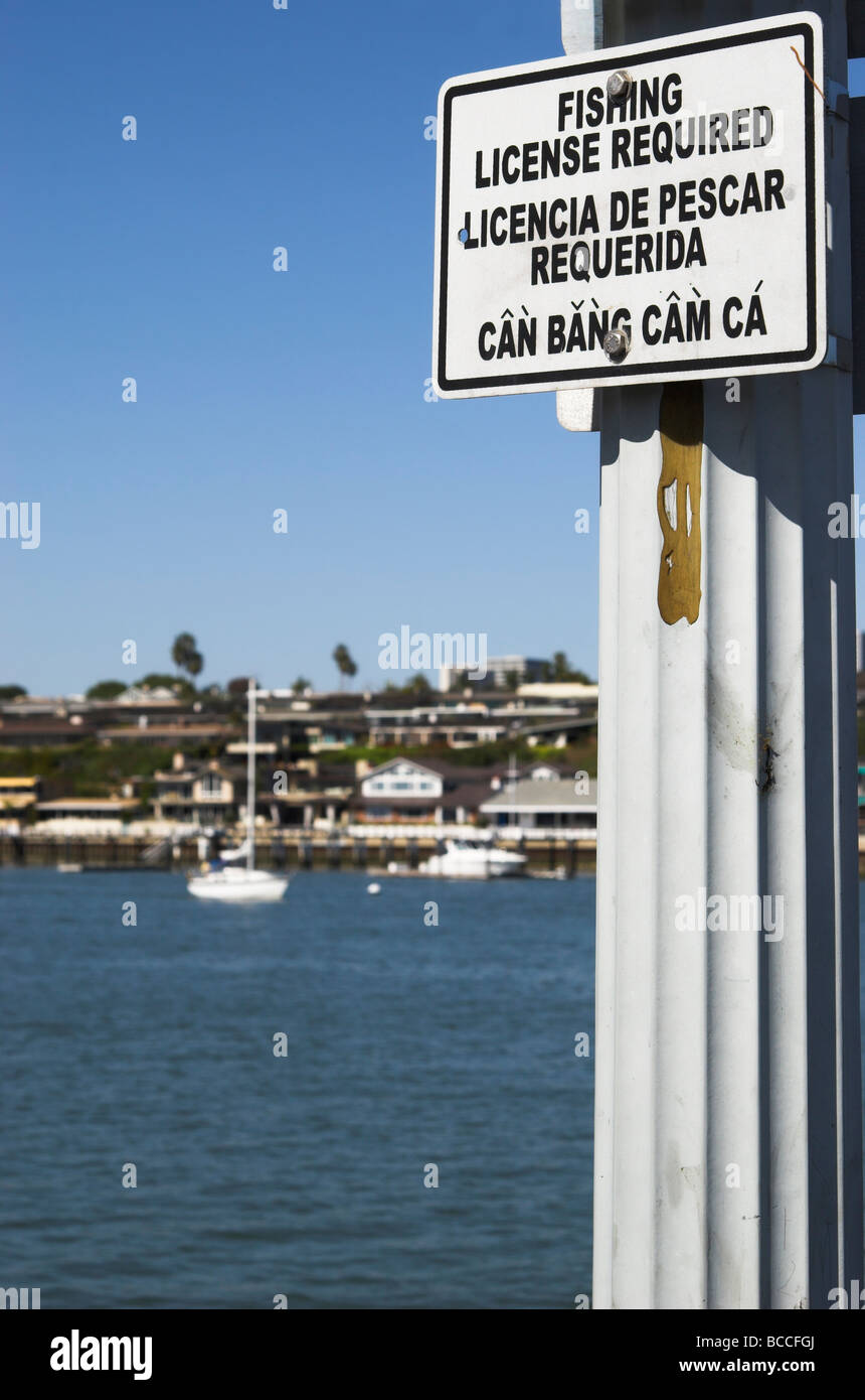 Trilingual sign at a public fishing pier in Newport Bay, Newport Beach, Orange County, California, USA. Photo Apr 2009. Stock Photo