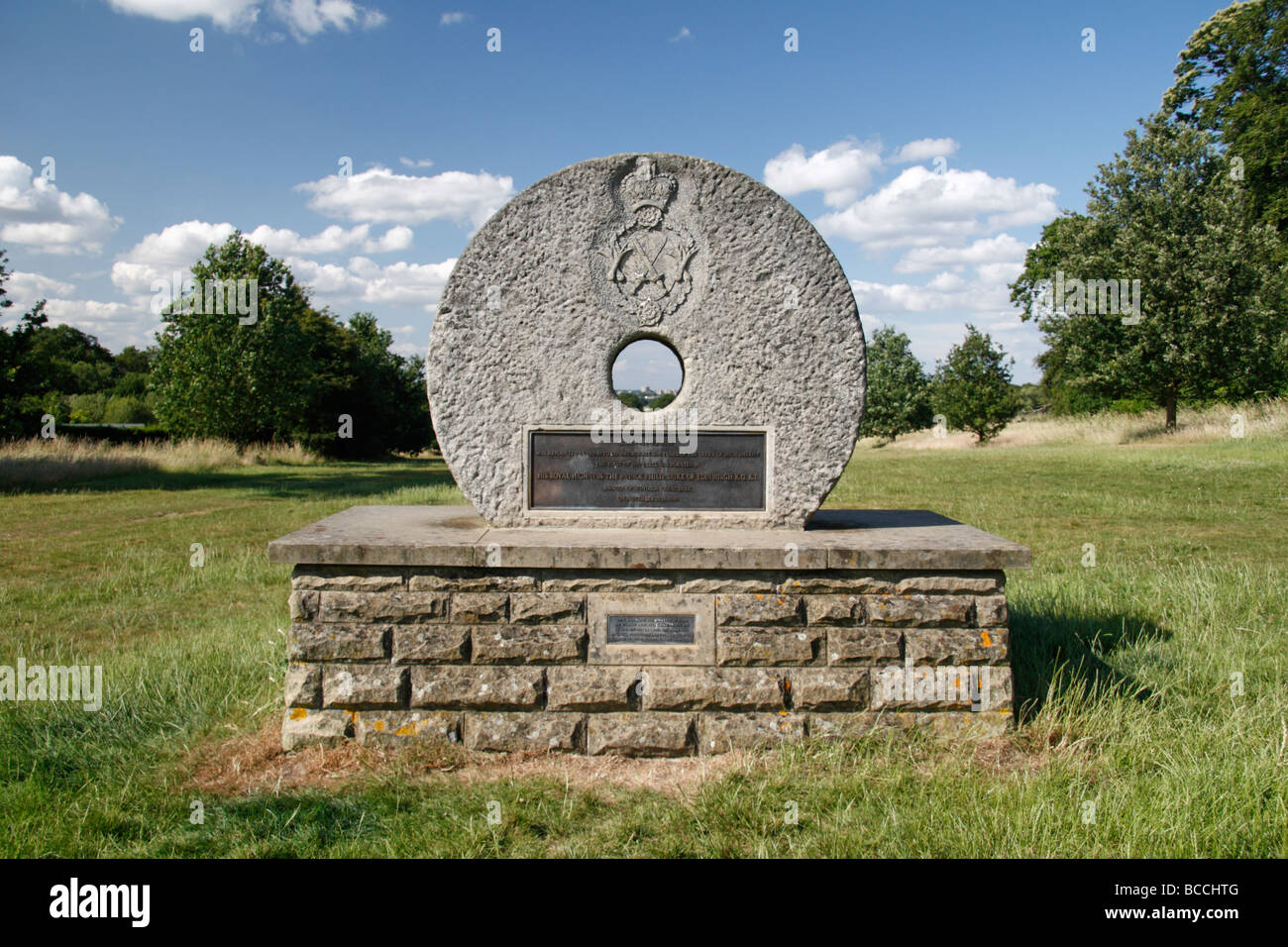 The Millstone Memorial on Queen Anne's ride in Windsor Great Park, Berkshire, England. Windsor Castle visable through hole. Stock Photo
