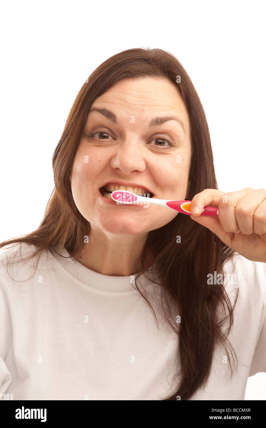 a thirty year old woman brushing her teeth Stock Photo