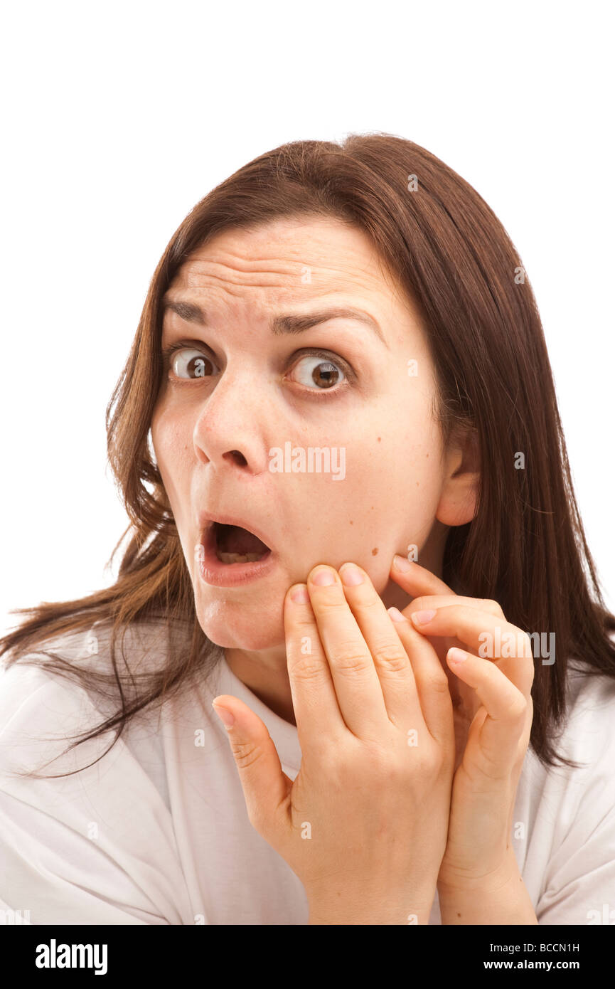 a thirty year old woman looking at her complexion checking her face Stock Photo