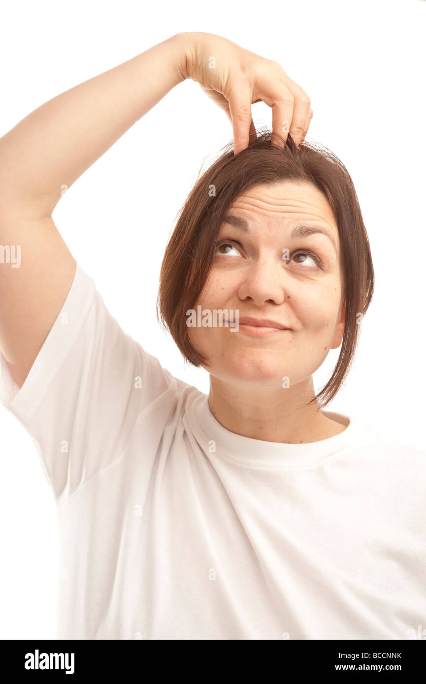 a confused young woman scratching her head Stock Photo Alamy