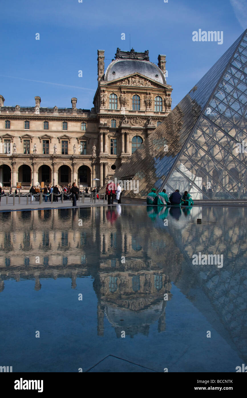 The Interior of Musee du Louvre Paris showing the glass entrance pyramid and triangular pools France Europe Stock Photo