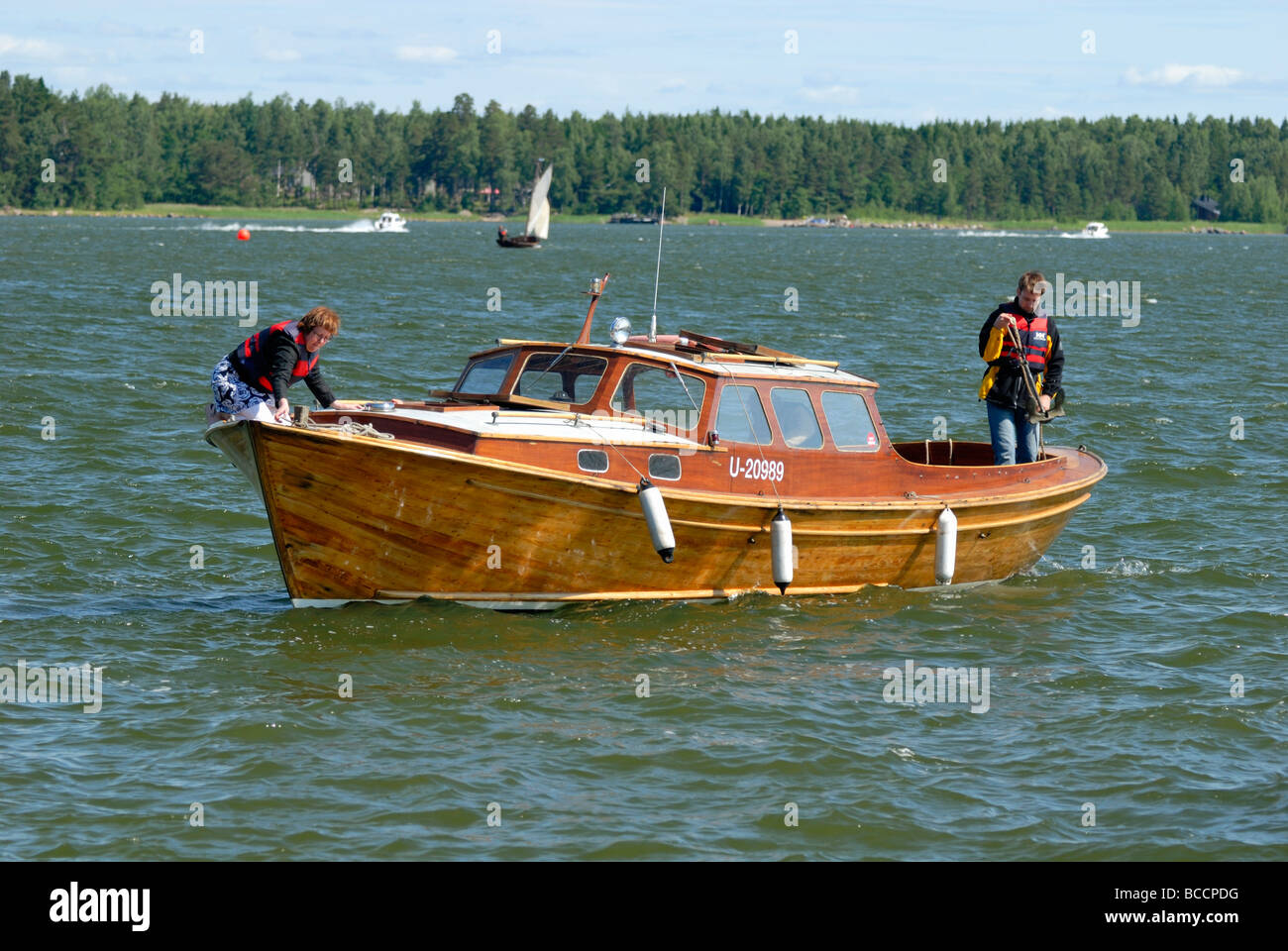 Traditional wooden motor boat leaving the marina in the ...