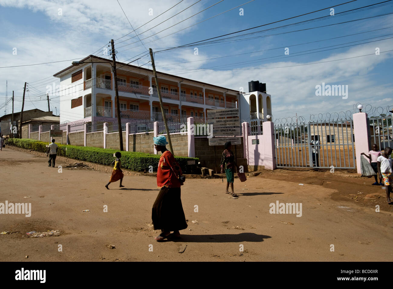 street in kamwockya slum kampala with secondary school Stock Photo