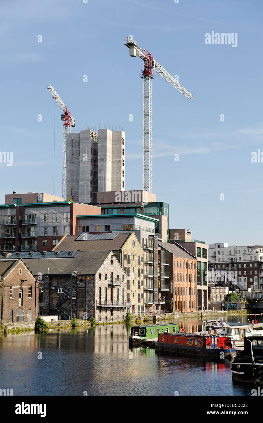 Tower block under construction amongst old warehouses of the Grand Canal Dock in Dublin Republic of Ireland Stock Photo