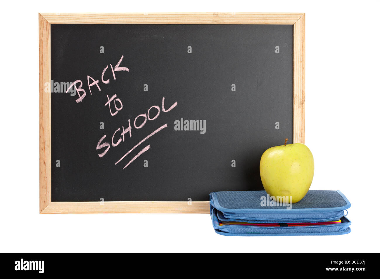 A pencil case and yellow apple over blackboard Shallow depth of field Stock Photo