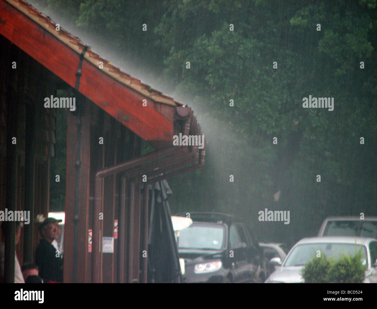 Rain pours off the roof of this Golf Clubhouse during a storm Stock Photo