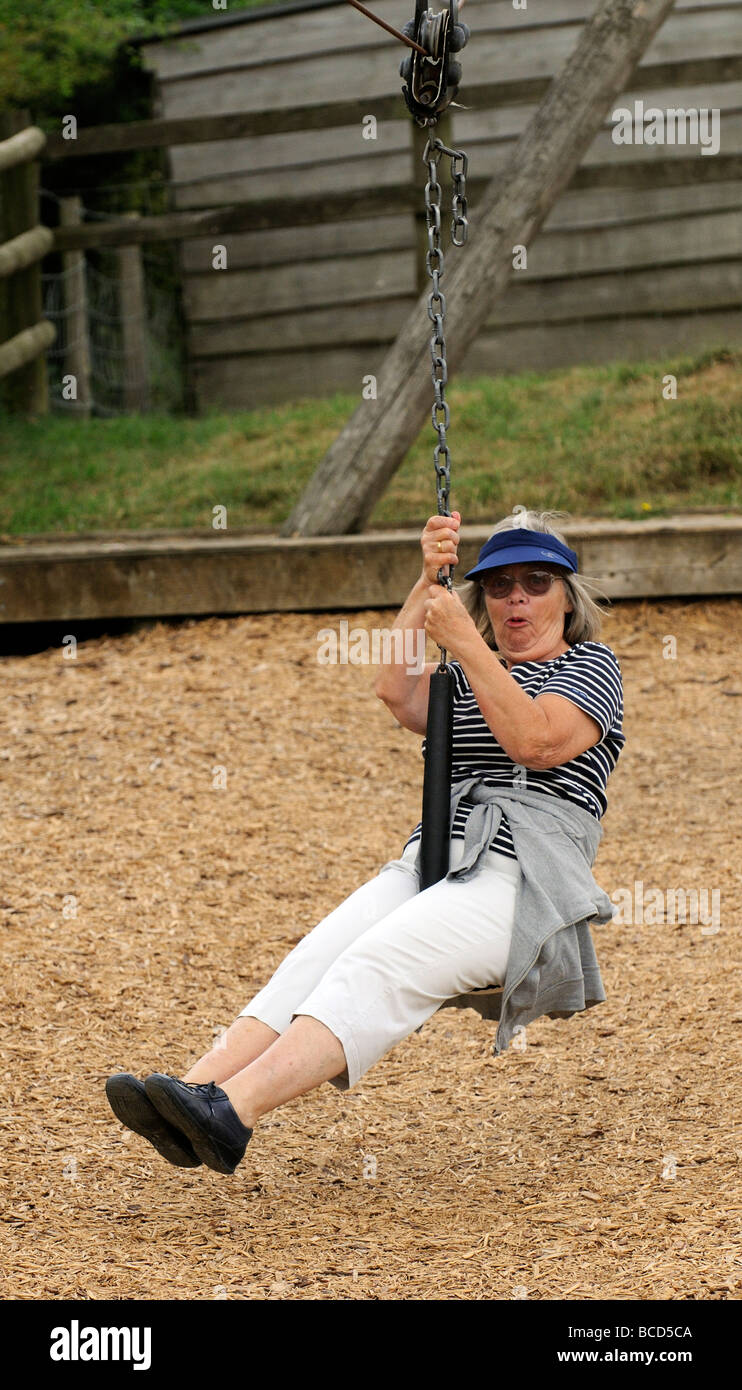 Elderly woman taking a zipline ride and enjoying her retirement years Stock Photo Alamy