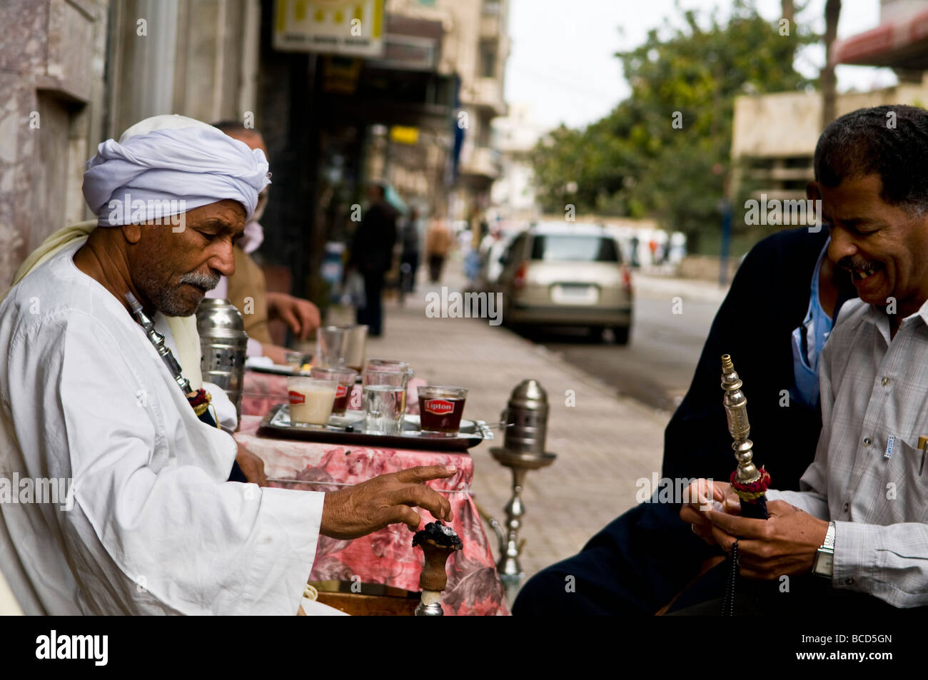 Smoking a Shisa water pipe after breakfast in a small Egyptian Cafe Stock Photo