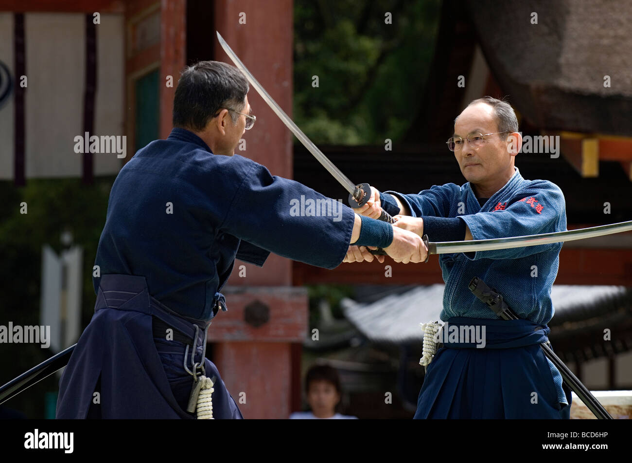 Two Men Engaged In A Sword Fight Using Real Samurai Swords During A