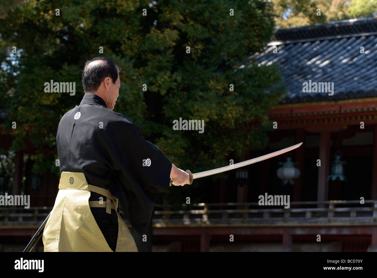 Man holding a real samurai sword during a swordsmanship exercise called