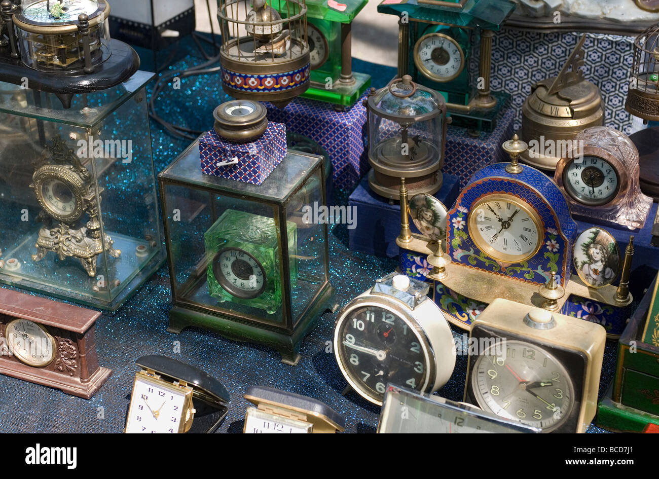 A collection of old clocks on display at an antique outdoor flea market ...