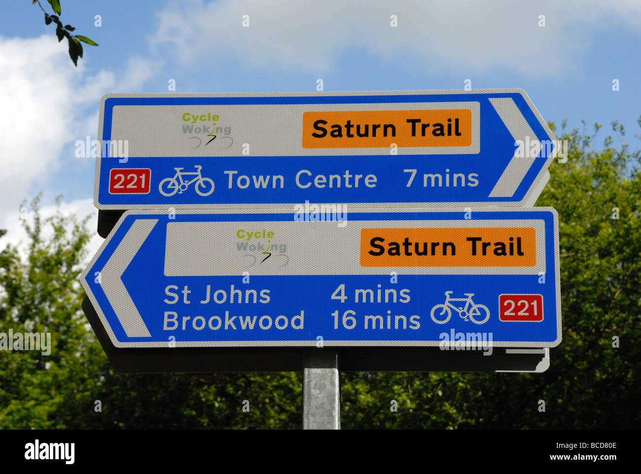 New cycle route signs to St John s Brookwood and Town Centre on the Basingstoke Canal at Langman s Bridge Goldsworth Park Woking Stock Photo