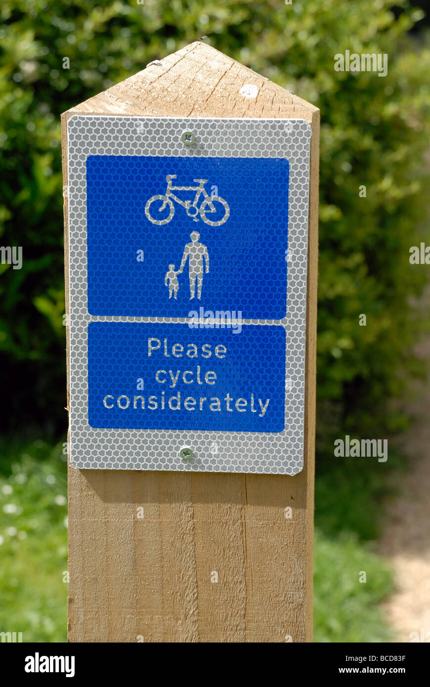 One of several Please cycle considerately cycle route signs on wooden posts along the Saturn Trail at St John s on the Basingsto Stock Photo