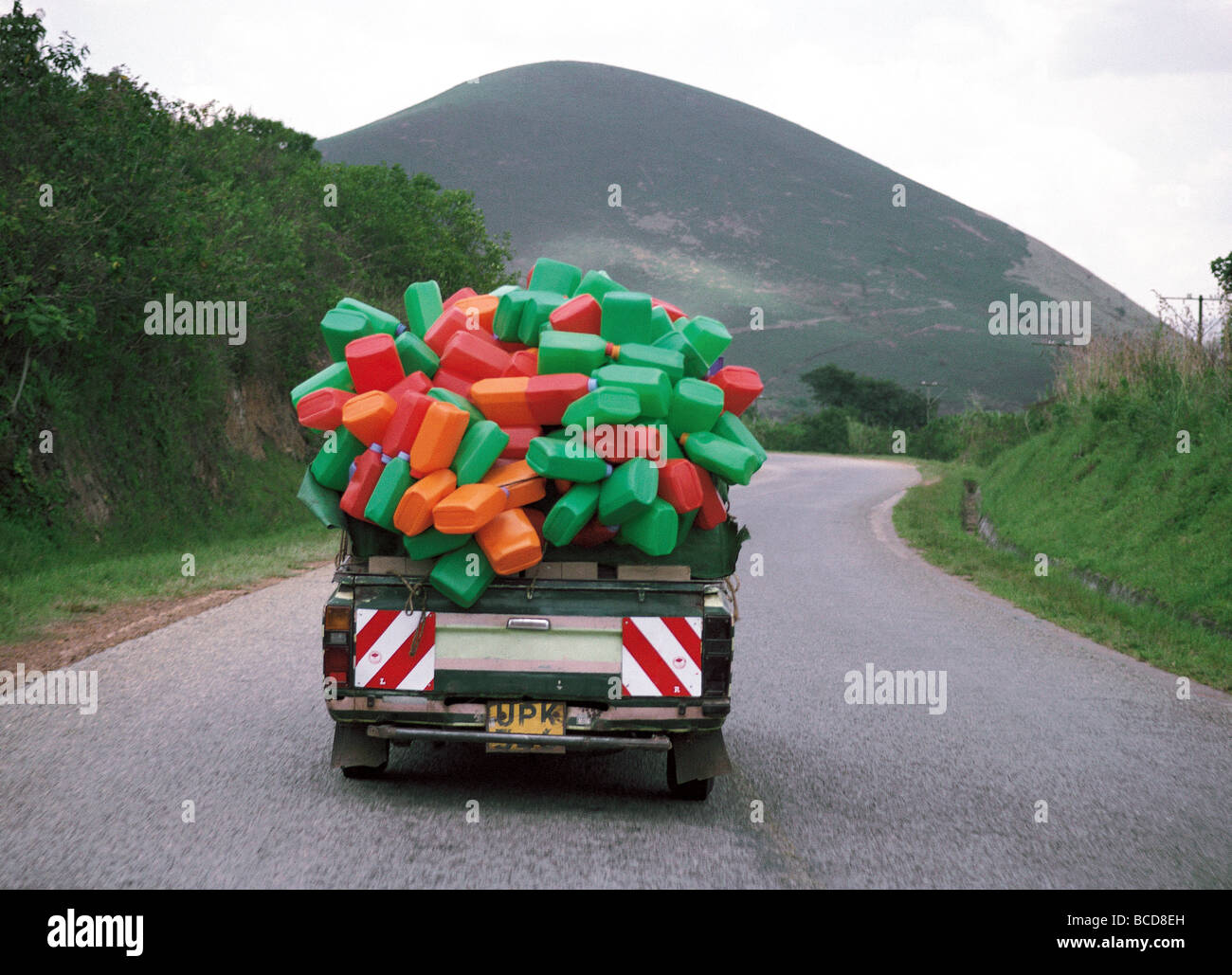 Pickup loaded with plastic water containers on Kabale Rwanda road in
