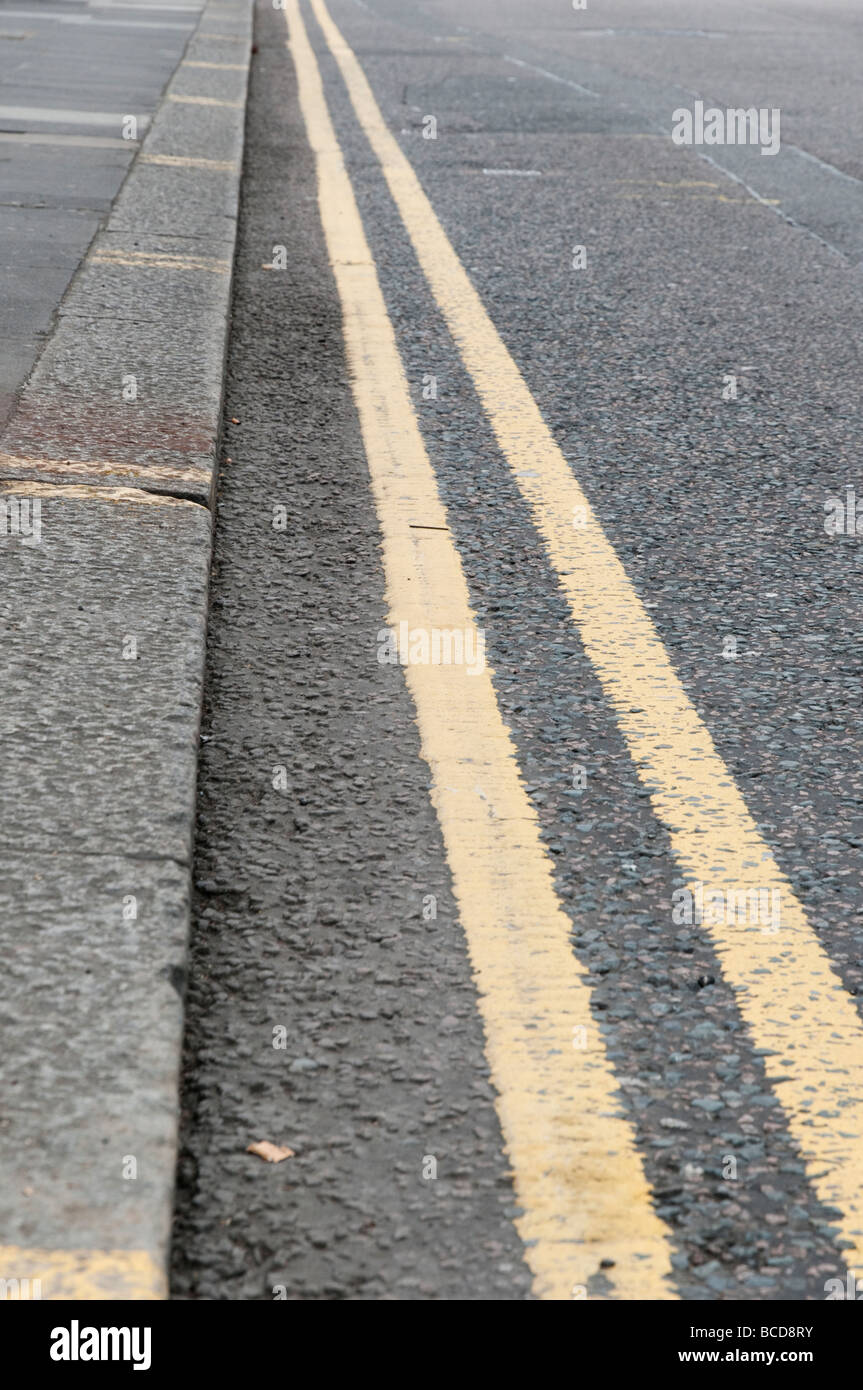 Double yellow line on street London England UK Stock Photo