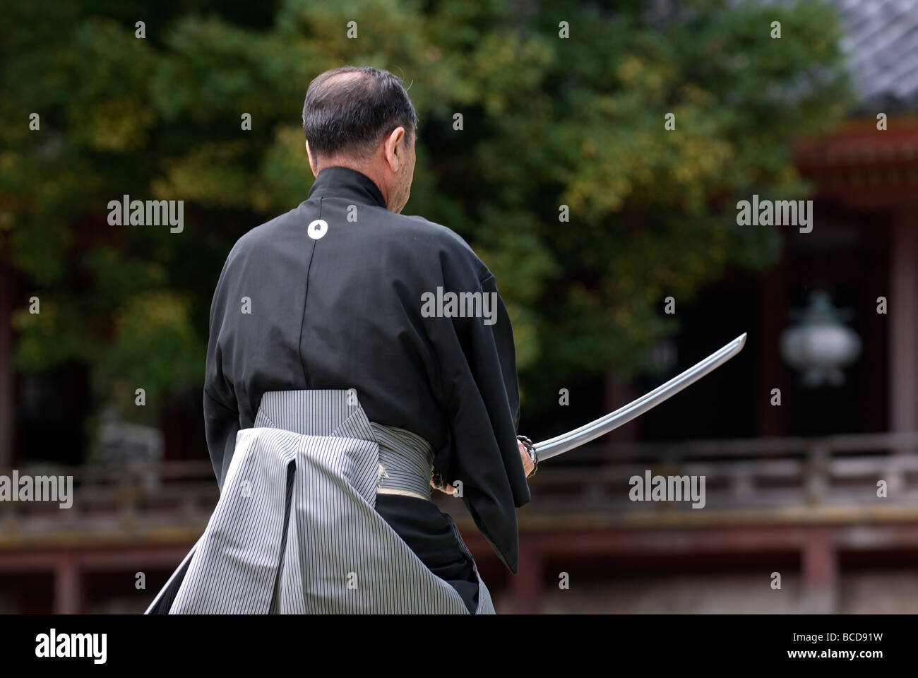 Man holding a real samurai sword during a swordsmanship exercise called