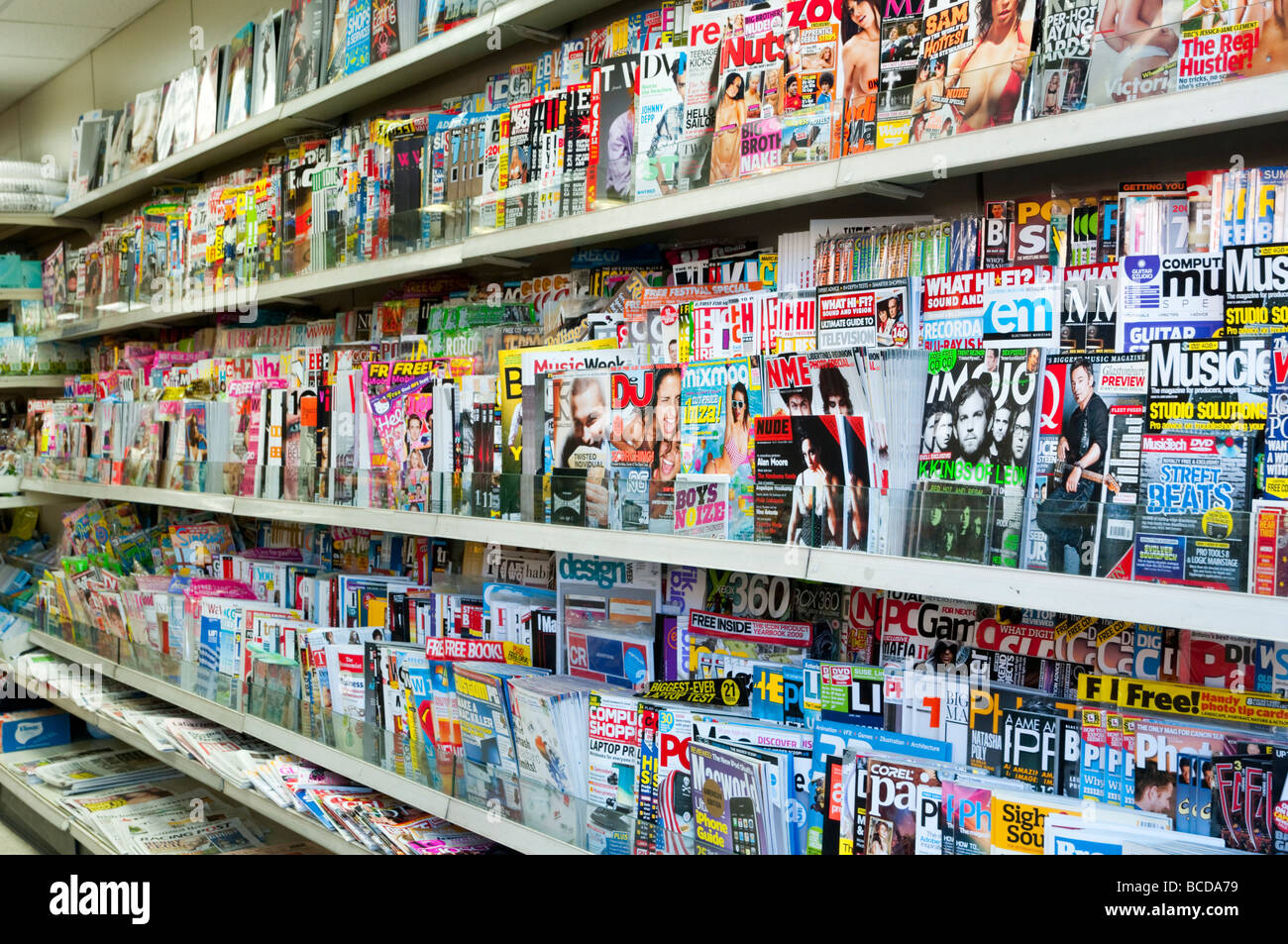 Magazines on rack of newsagent, London England UK Stock Photo