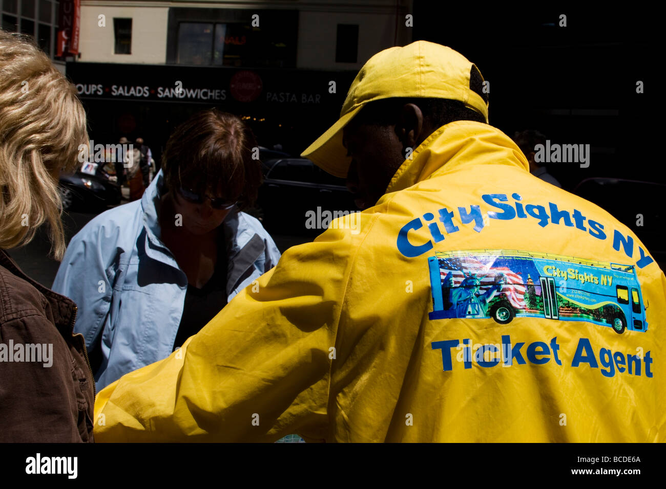 Man selling tickets for City Sights bus tours in New York City, USA Stock Photo