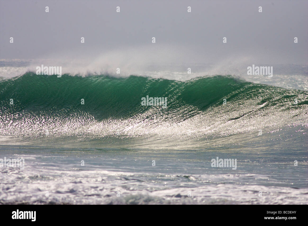 A wave breaks onto the reef at Porthleven in Cornwall Stock Photo