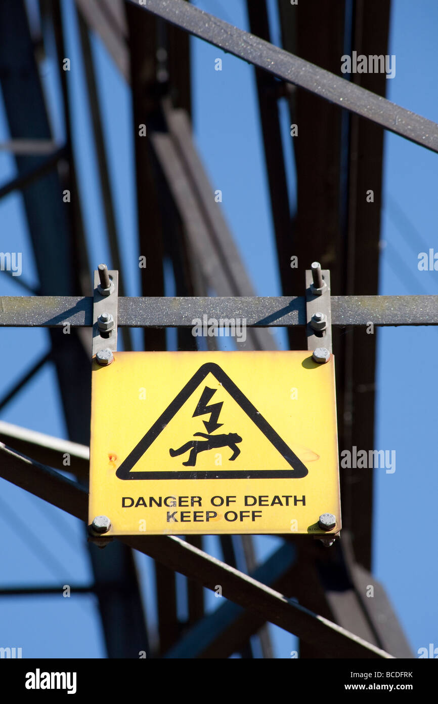 Yellow warning sign on Electricity Pylon reading Danger Of Death Keep Off. Lee Valley nature reserve, Lee Valley, London, UK Stock Photo