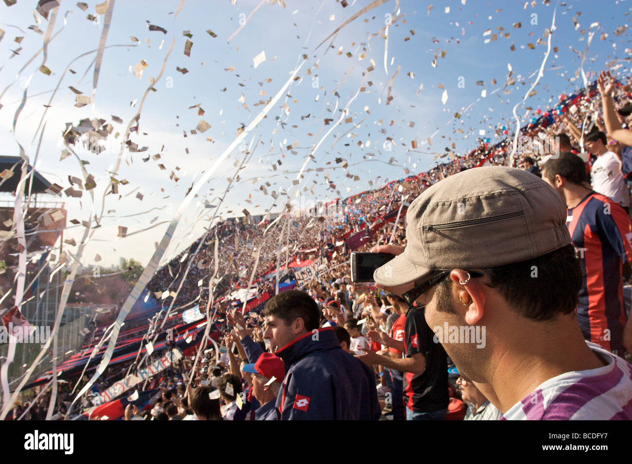 Fans of football team San Lorenzo celebrate as their players take to the pitch for a match against Racing. Stock Photo