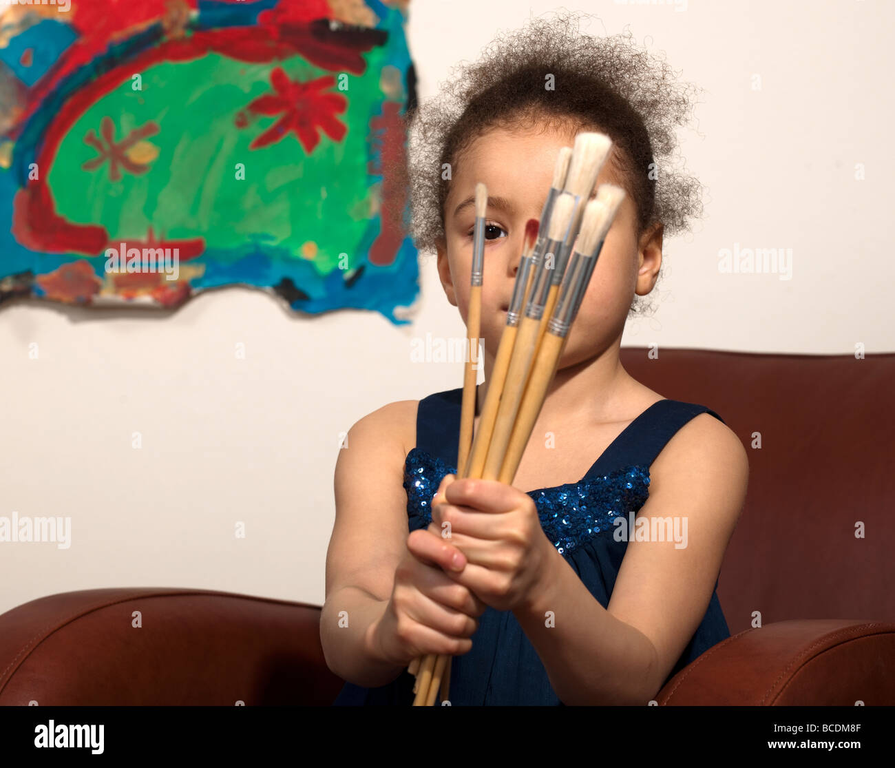 Young girl with paint brushes Stock Photo