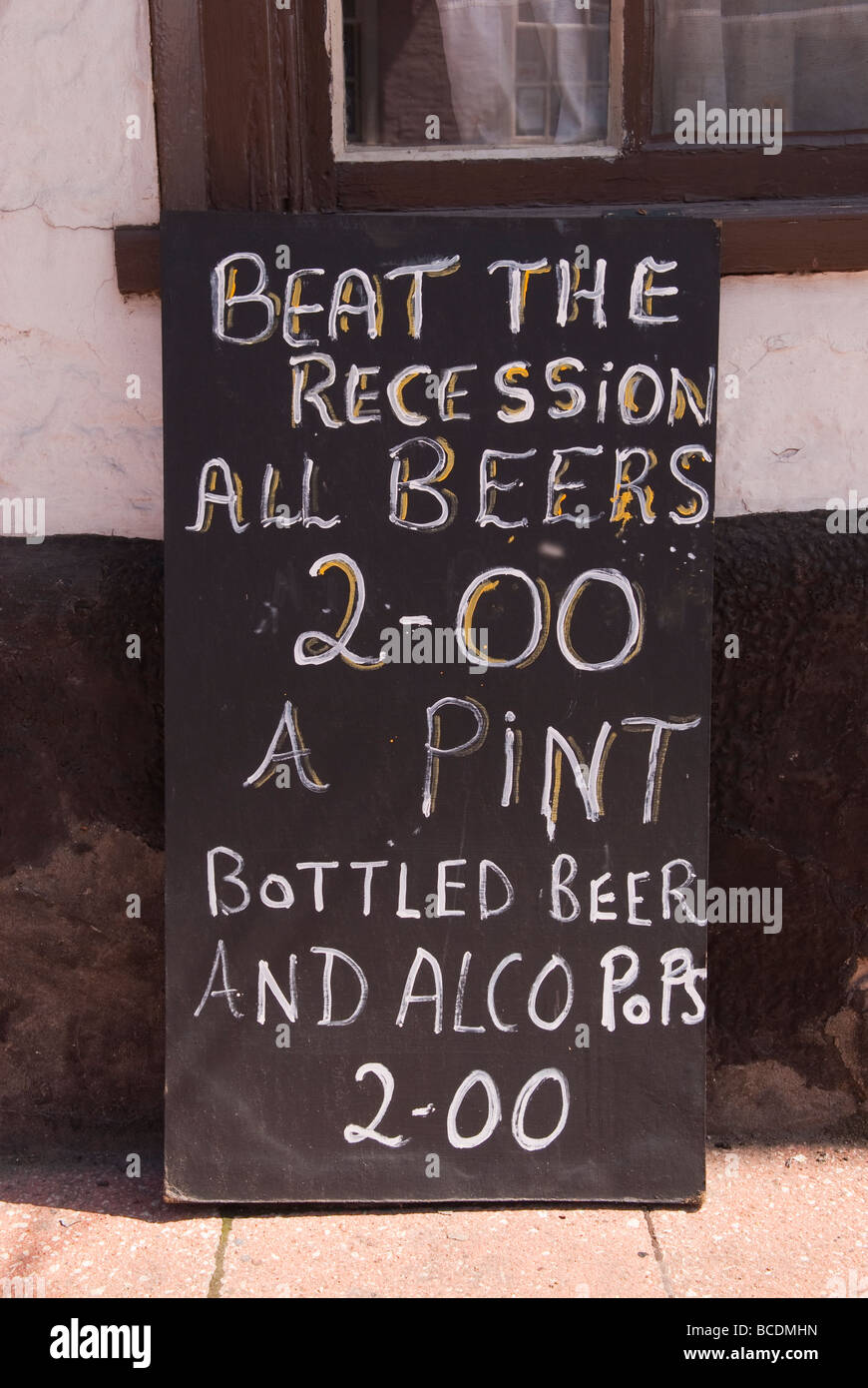 A sign outside a Uk pub advertising cheap drinks Stock Photo