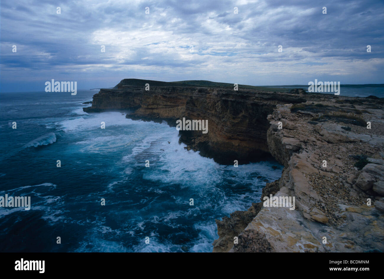 A limestone peninsula juts into a storm ravaged Southern Ocean. Stock Photo