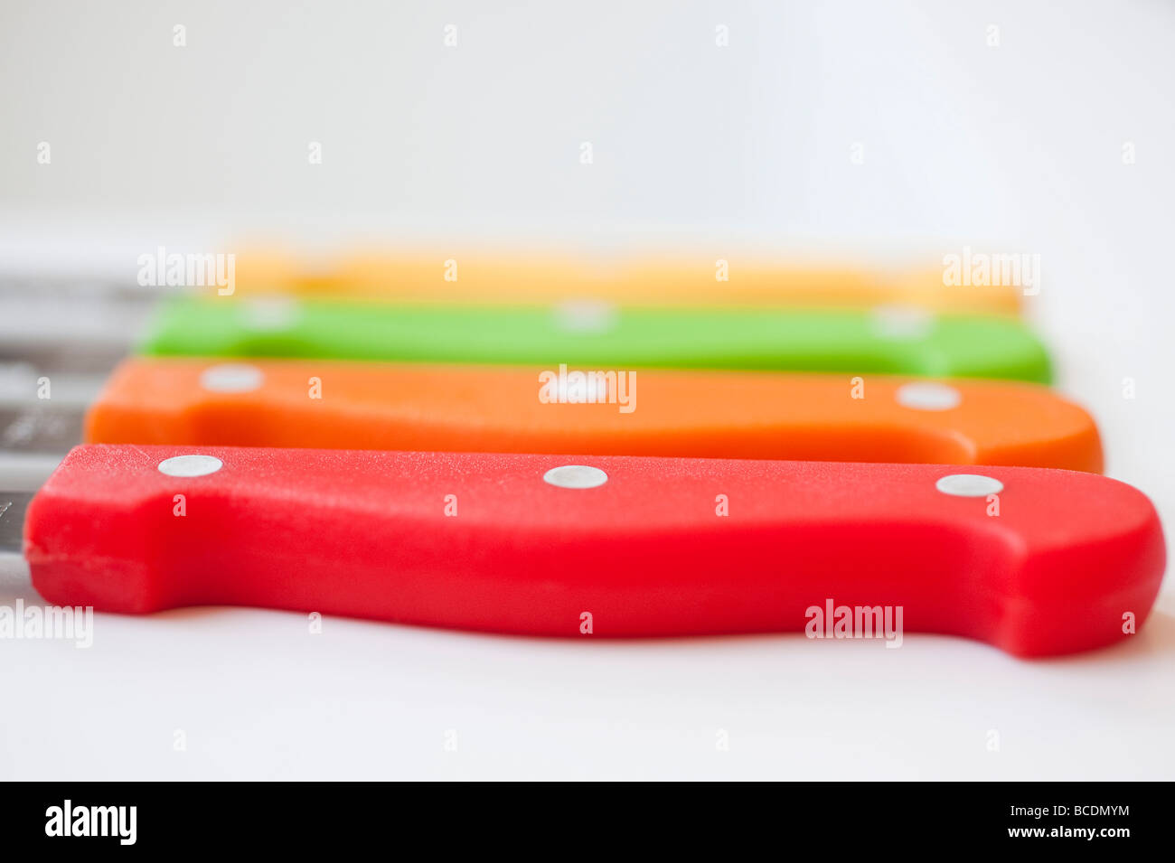 Cutout of colourful steak knives on white background Stock Photo Alamy